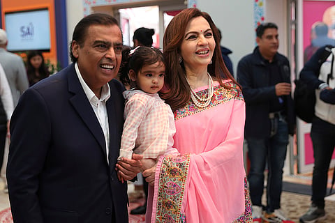 Mukesh Ambani, with his wife Nita Ambani and grand-daughter Aadiya